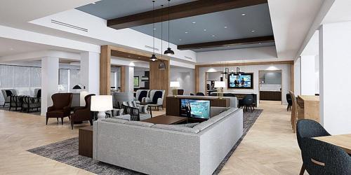 桑顿Staybridge Suites - Denver North - Thornton, an IHG Hotel的客厅配有沙发和椅子