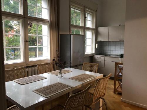 柏林柏林伊拉公寓酒店的厨房配有白色的桌子和一些窗户。