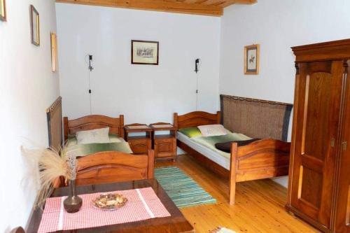 BakonykoppányKoppány Lovasudvar的客厅配有两张床和一张桌子