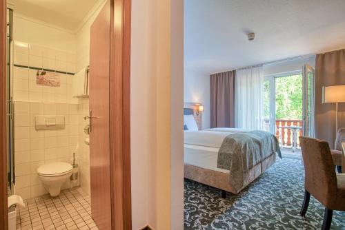 巴德贝芬森Sporthotel Bad Bevensen的一间酒店客房 - 带一张床和一间浴室