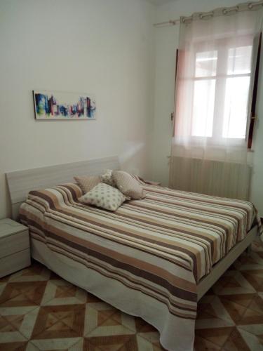 蒙德罗Appartamento a Mondello的卧室内的一张大床,设有窗户