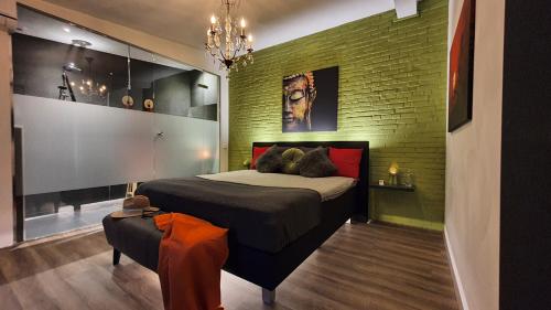 埃因霍温Downtown Hideaway, B&B Grand Deluxe的一间卧室设有一张床和绿色砖墙