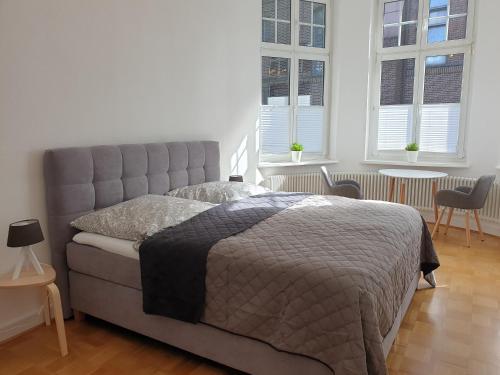 波鸿Apartment Villa Kronenberg的一间卧室设有一张床和两个窗户。