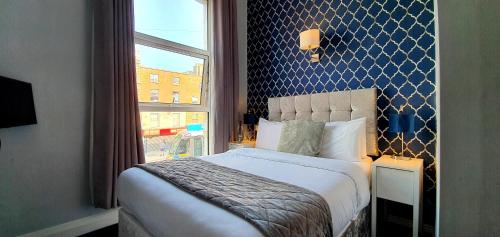 都柏林The Gate Hotel的一间卧室设有一张大床和一个窗户。
