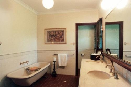 布鲁姆Pinctada McAlpine House的带浴缸、水槽和镜子的浴室
