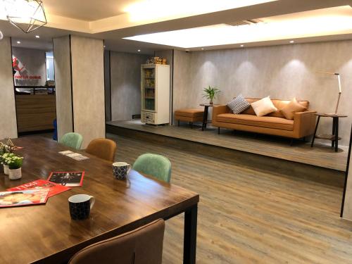 香港灏美连锁式旅舍 - 北角的客厅配有桌子和沙发