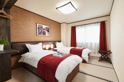 妙高赤仓旅馆的酒店客房设有两张床和窗户。
