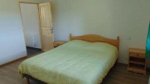 Belmont-sur-ButtantAppartement 52m2 - Location vacances Vosges的一间卧室配有床和两张木桌
