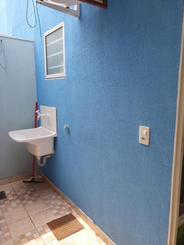 大坎普Kitnet Camiloca的一间带水槽和蓝色墙壁的浴室