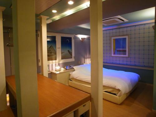 所泽市HOTEL K VILLAGE的卧室配有一张床和一张桌子