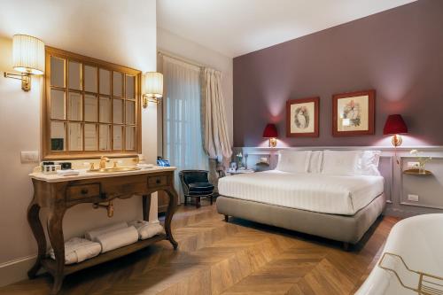 佛罗伦萨Corte Calzaiuoli Elegant Suites的一间卧室配有一张床、一张桌子和一个水槽