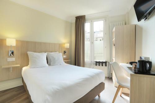 巴黎穆拉酒店的酒店客房设有一张白色大床和一张书桌