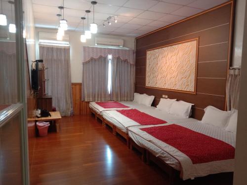 小琉球岛小琉球蓝沙民宿的铺有木地板的客房内的两张床