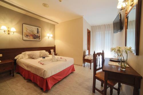坎巴多斯圣马科斯撒尼斯酒店的配有一张床和一张书桌的酒店客房