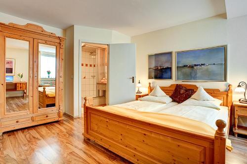 代特莫尔德代特莫尔德斯塔德特酒店的一间卧室配有一张大型木床