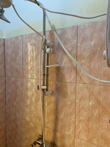 KisoroMondi Lodge Kisoro的瓷砖墙上带水管的淋浴
