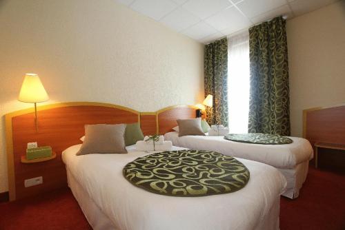 朗巴勒朗巴勒基里亚德酒店的酒店客房设有两张床和窗户。