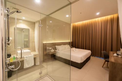 芙蓉D&F BOUTIQUE HOTEL SEREMBAN 2的浴室设有床铺和玻璃淋浴间。