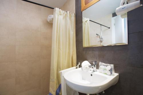 圣蓬萨普拉萨玛宁静公寓的一间带水槽和淋浴帘的浴室
