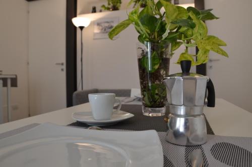 贝内文托Belle Donne Apartment的一张桌子,上面有咖啡壶和杯子