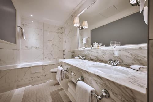 因特拉肯维多利亚少女峰温泉大酒店的一间带水槽和大镜子的浴室