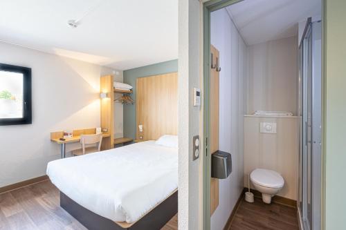 圣锡尔万当茹B&B HOTEL Angers Parc Expos的酒店客房设有一张床和一个卫生间。