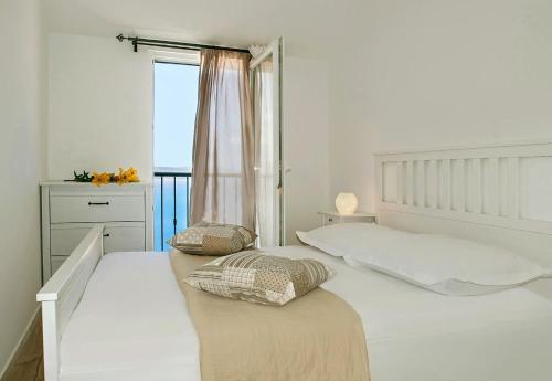 奥米什House Dunja的白色的卧室设有床和窗户