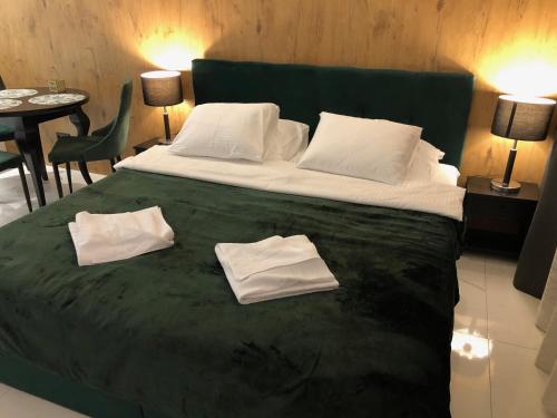 弗罗茨瓦夫GREEN 25 - Angel River的一间卧室配有一张大床和两条毛巾