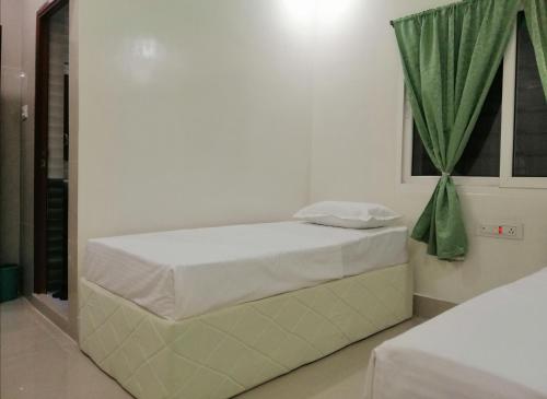 RAJHAT MARANAO House客房内的一张或多张床位