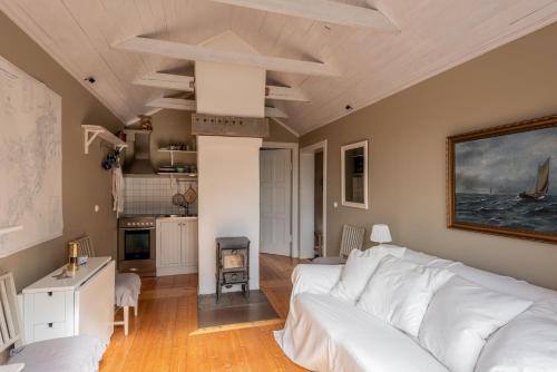 瓦克斯霍尔姆Vaxholm Seaview Cottage的一间带白色沙发的客厅和一间厨房
