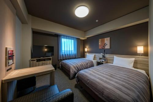 Hotel Route-Inn Kamisu客房内的一张或多张床位