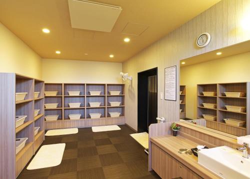 EchizenHotel Route-Inn Takefu Inter的一间带水槽和书架的大浴室