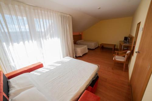 瓜达拉哈拉托卡酒店的一间卧室设有一张床和一个大窗户