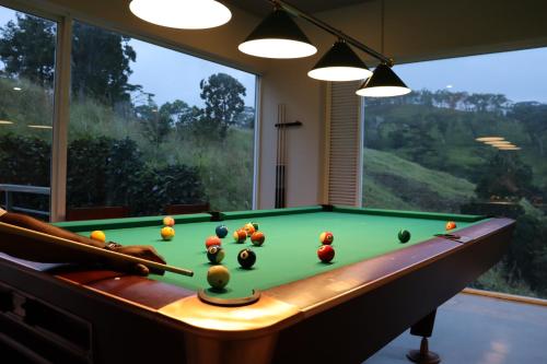 康提Skyloft Kandy by Aaradhya的窗户房间里一张带球的台球桌