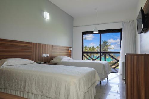 Aram Imirá Beach Resort客房内的一张或多张床位