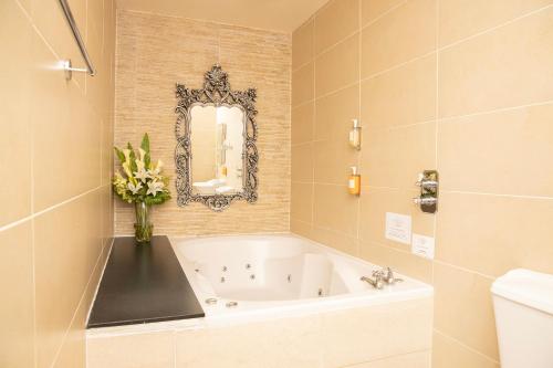 利物浦30詹姆斯街酒店的带浴缸和花瓶的浴室