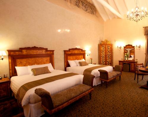 阿拉纳库斯科精品酒店客房内的一张或多张床位