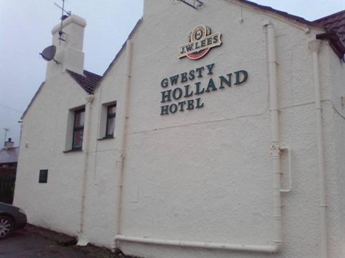LlanfachraethHolland Hotel的白色的建筑,旁边标有标志