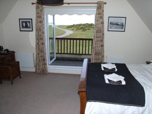纽布里奇The Curragh Country House Accommodation的一间卧室设有一张床和一个大窗户