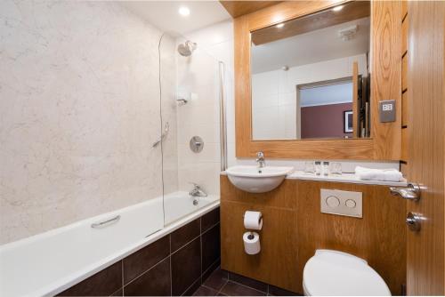 纽敦纳兹斯特兰福德纹章酒店的一间带水槽、卫生间和镜子的浴室