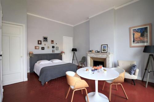 马赛Maison Dormoy的卧室配有一张床和一张桌子及椅子