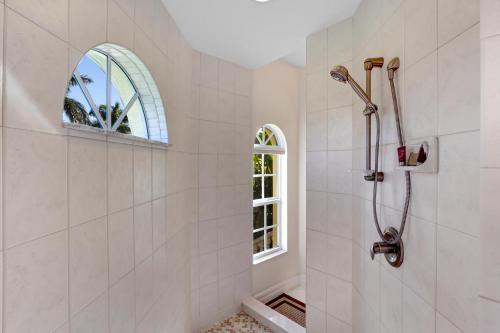 珊瑚角Villa Bel Air的带淋浴的浴室和窗户。