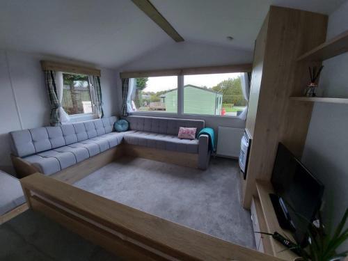 纳尔斯伯勒Woofles Luxury Caravan at Knaresborough Lido的带沙发和电视的客厅
