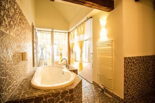 Feldkirchen bei Graz基瓦诺格拉茨酒店的大型浴室设有浴缸和淋浴。