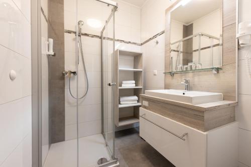 延纳斯多夫洛珀斯朵夫玛丽亚特里萨霍夫酒店的白色的浴室设有水槽和淋浴。
