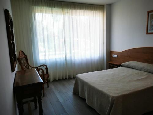 圣维森德马尔Loft Pedras Negras的一间卧室设有一张床和一个大窗户