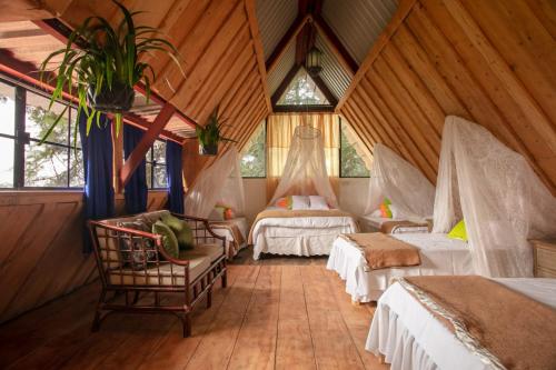 Los Naranjos洛斯纳兰霍斯度假屋的一间带两张床铺的卧室,位于带木墙的房间内