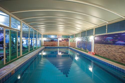 利雅德梅拉尔皇冠酒店的一座带天花板的建筑中的游泳池