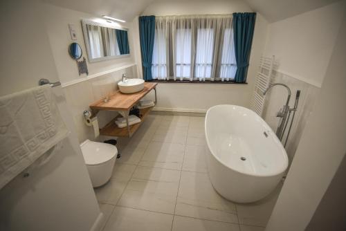 希欧福克坎帕纳别墅酒店的带浴缸、卫生间和盥洗盆的浴室