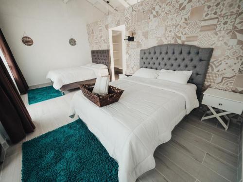 福尔图纳Hotel Arenal Vista Lodge的一间卧室配有两张带白色床单的床